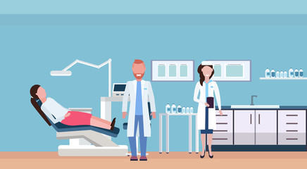 couple dentists examining woman patient lying in dentistry chair professional dental office modern clinic interior male female characters full length flat horizontal