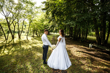 Happy wedding couple in beautiful park. Wedding photography.