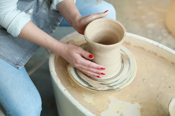 girl makes a jug of his own hands in a pottery workshop
