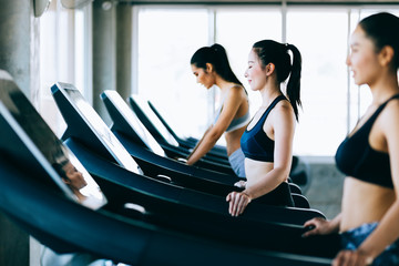 Side view group of healthy attractive sports women on running track. Healthy, sports, lifestyle, Fitness gym concept.