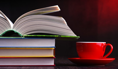 Composition with books and cup of coffee on the table