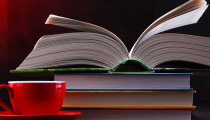 Composition with books and cup of coffee on the table
