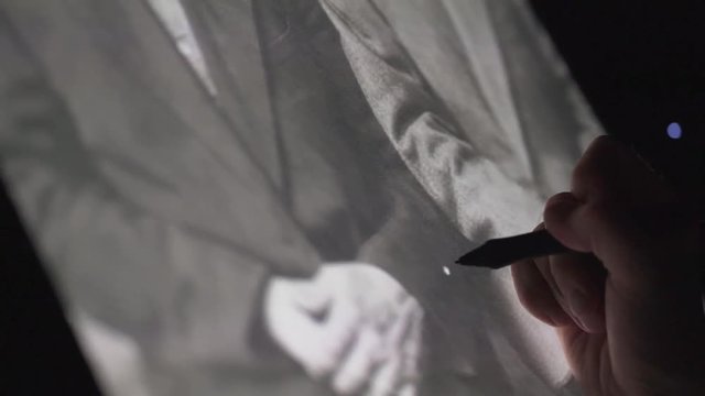 Digital artist retoucher edit an old retro photograph on interactive tablet computer in night home office. Freelancer man working late from home