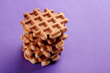 Homemade Viennese waffles on purple background