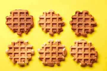 Homemade Viennese waffles on yellow background