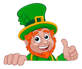 A Leprechaun St Patricks Day Irish cartoon character peeking over a banner or sign and doing a thumbs up