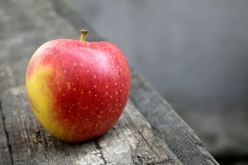 Beautiful fresh juicy ripe red apple lies on the table summer
