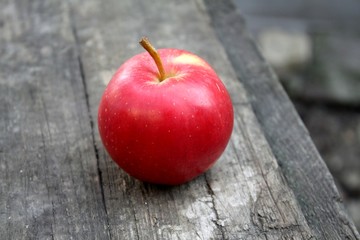 Beautiful fresh juicy ripe red apple lies on the table summer