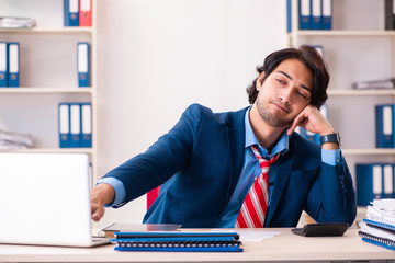 Young handsome businessman sitting in the office 