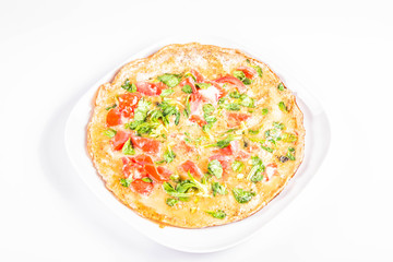 Omelette with tomatoes and fresh corn salad on a white background