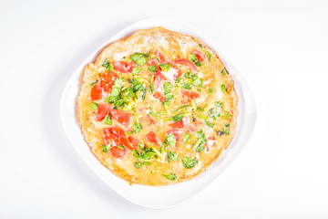 Omelette with tomatoes and fresh corn salad on a white background