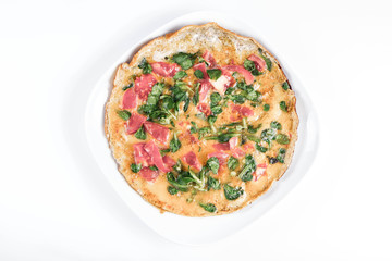Omelette with tomatoes and fresh corn salad on a white background