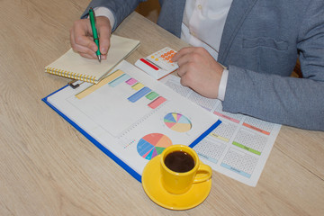 Close up view of bookkeeper or financial inspector hands making report, calculating or checking balance