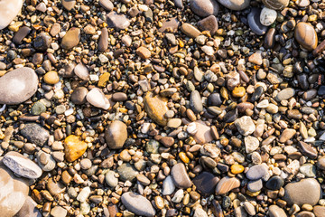 Flat lay of pebbles pattern on the sea shore.
