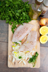 Fresh fish, raw cod fillets with addition of herbs and lemon
