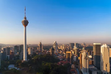 Foto auf Leinwand Menara Kuala Lumpur Tower with sunset sky. Aerial view of Kuala Lumpur Downtown, Malaysia. Financial district and business centers in urban city in Asia. Skyscraper and high-rise buildings at noon. © tampatra