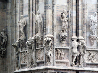 Fototapeta na wymiar The famous Cathedral of Milan (Italian: Duomo di Milano), the Cathedral of the Nativity of the Virgin. Details of the church close-up. Lombardy, Italy