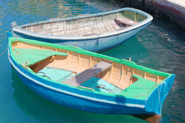 Colorful blue and green traditional fishing boats in the harbor in Malta