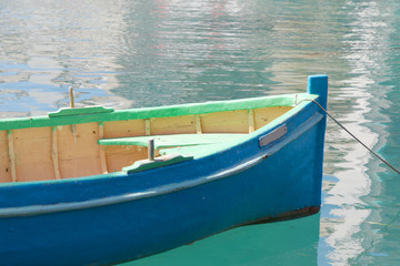 Closeup of colorful blue and green traditional fishing boat in the harbor in Malta