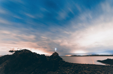 Stunning night scapes of stars milky way and nebula with views of Cape Roger Curtis on Bowen Island's lighthouse