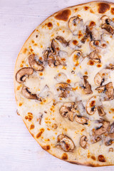 A julienne chicken and mushrooms pizza in cheese sauce