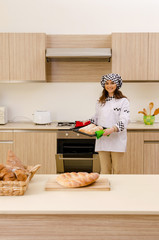 Young female baker working in kitchen 