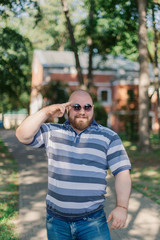 .Young man with round glasses and overweight in the park.