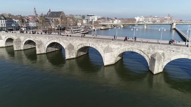 Aerial bird view footage Sint Servaasbrug in English knowns as St. Servatius Bridge is an arched stone footbridge across Meuse River in Maastricht the Netherlands and the oldest one in Holland 4k