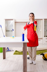 Young beautiful woman cleaning apartment 