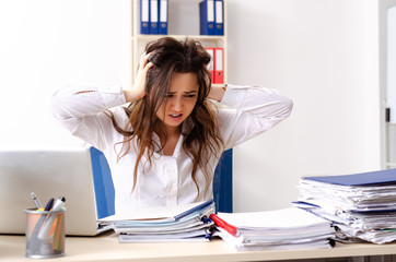 Young female employee unhappy with excessive work 