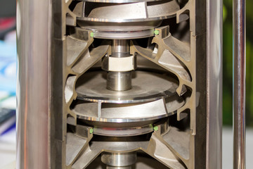 Close up cross section detail impeller and inside centrifugal multistage ring vertical pump for...