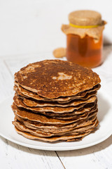 a stack of homemade pancakes, vertical closeup