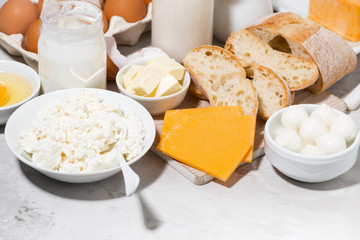 assortment of fresh farm dairy products on white table, closeup