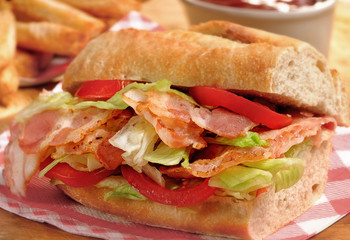 Bacon, lettuce and tomato (BLT) sub sandwich from freshly cut baguette. 