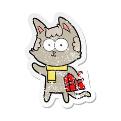distressed sticker of a happy cartoon cat with christmas present