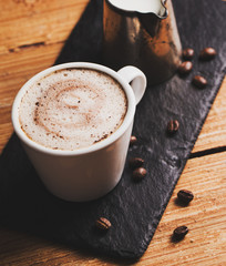 Black coffee with milk flatlay view on wooden background