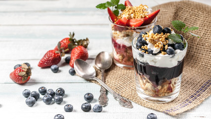 Tasty layered dessert with muesli and berries