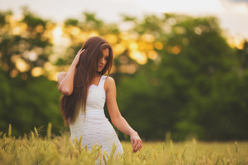 beautiful woman posing in yellow wheat field