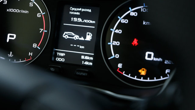 Close-up of a modern dashboard in an expensive car. The steering wheel is blurred. Advanced technology concept