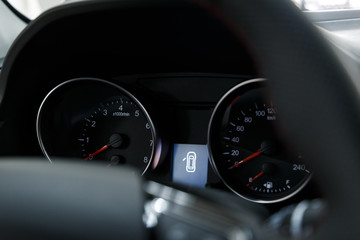 Glowing beautiful dashboard of a modern expensive car. The interior of the car. The foreground is...