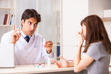 Young woman visiting male doctor ophthalmologist in hospital