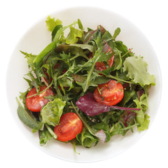 Arugula salad with tomatoes served on a plate. Isolated on white background. View from above.