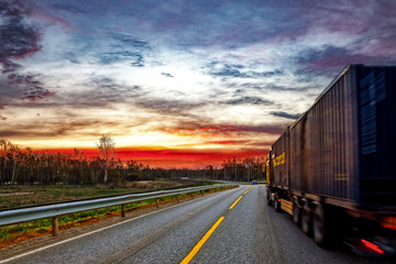 Fototapeta na wymiar Truck transport on the road at sunset.
