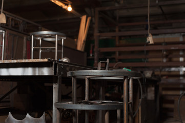 Row of metal chairs in blacksmith workshop