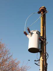 metal bucket hanging on pole electrics outside wires