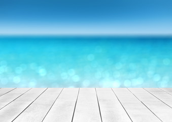 wooden table top with blur ocean background summer concept