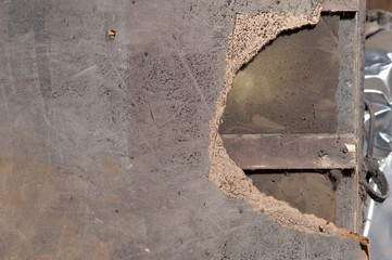 Surface of sawdust door with a piece torn