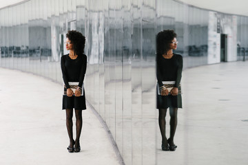 Urban professional stylish businesswoman symmetry reflection outside.