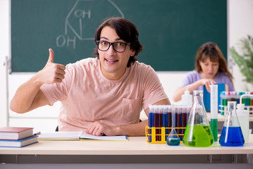 Two chemists students in classroom 