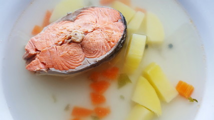 Seafood soup. Soup with salmon in a white plate.